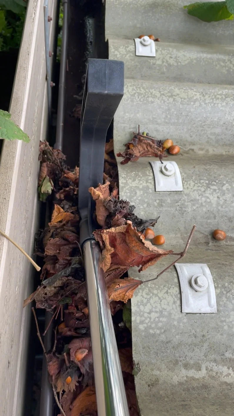 Dakgootreiniger/dakgoothaak voor bladeren en mos/takken naar u toe te vegen.